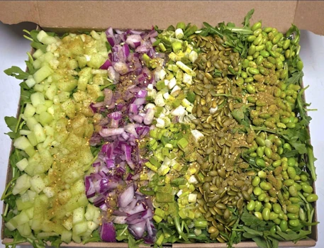 Photo of Tray of Arugula & Toasted Pumpkin Seed Salad