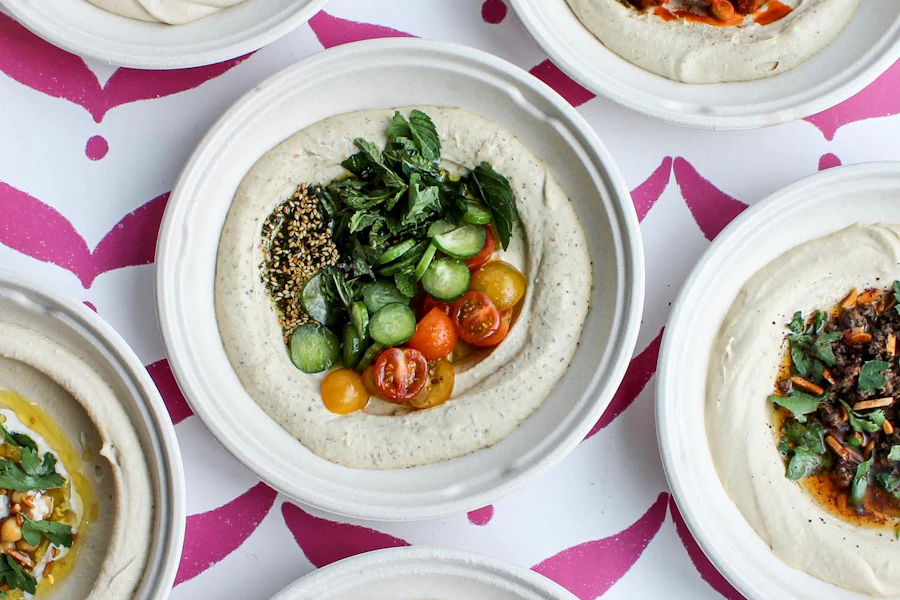 Baba's Hummus House & Mana'eesh Bakery Corporate Catering and Group Ordering located at 2220 Lyndale Ave S, Minneapolis, MN 55405, USA. Baba's Hummus House & Mana'eesh Bakery's top menu items include Tahini Caesar Salad, Jerusalem-Style Bowl, Wagyu Shawarma Bowl.