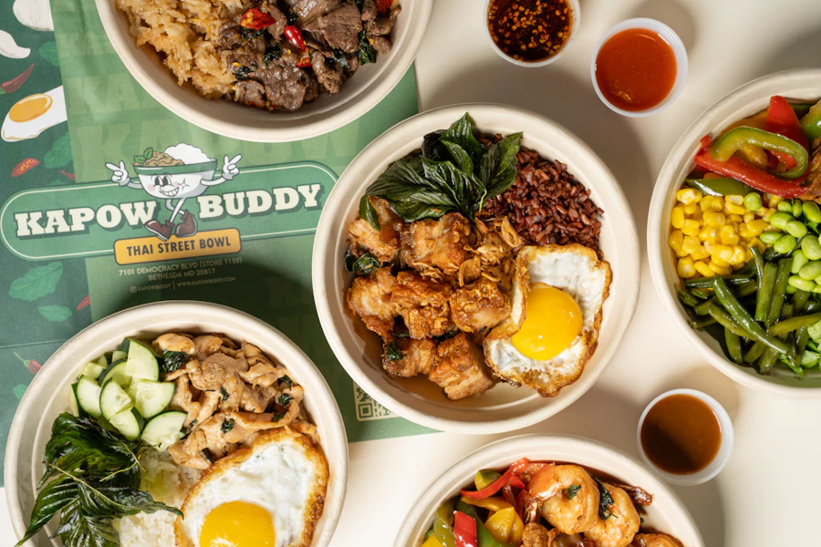 Kapow Buddy Corporate Catering and Group Ordering located at 7101 Democracy Blvd, Bethesda, MD 20817, USA. Kapow Buddy's top menu items include Large Bowl Bar Package, Small Bowl Bar Package, 1/2 Gallon Bottle of Butterfly Pea Tea Lemonade.